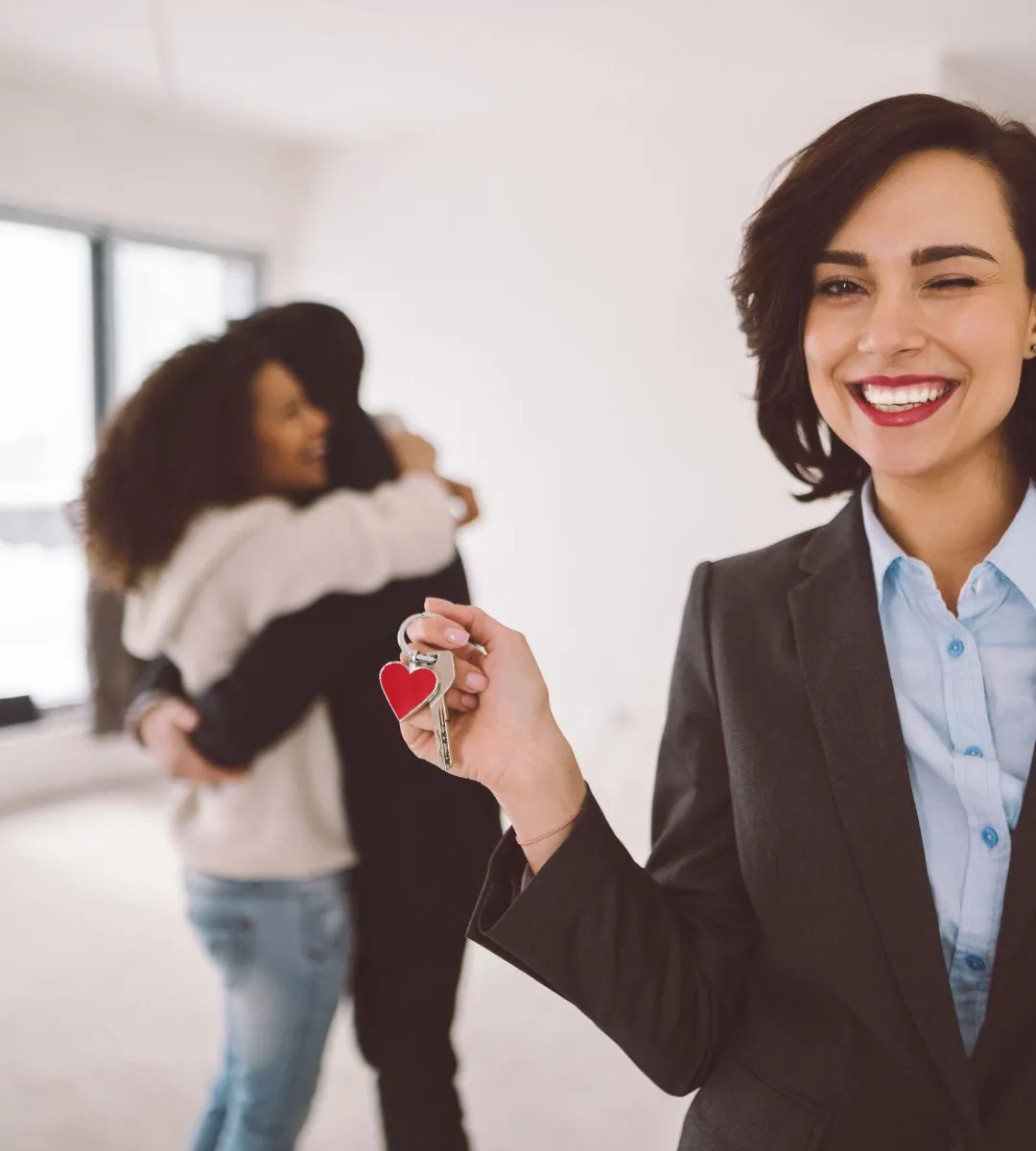 Real estate agent handing keys to client at closing